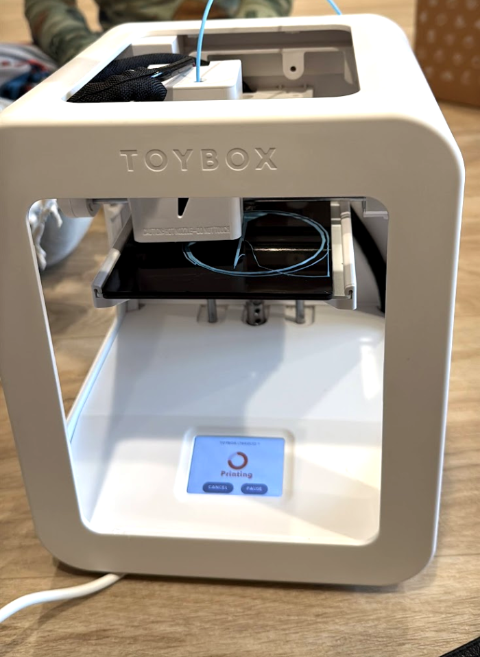 A Toybox printer part way through a print in light blue filament